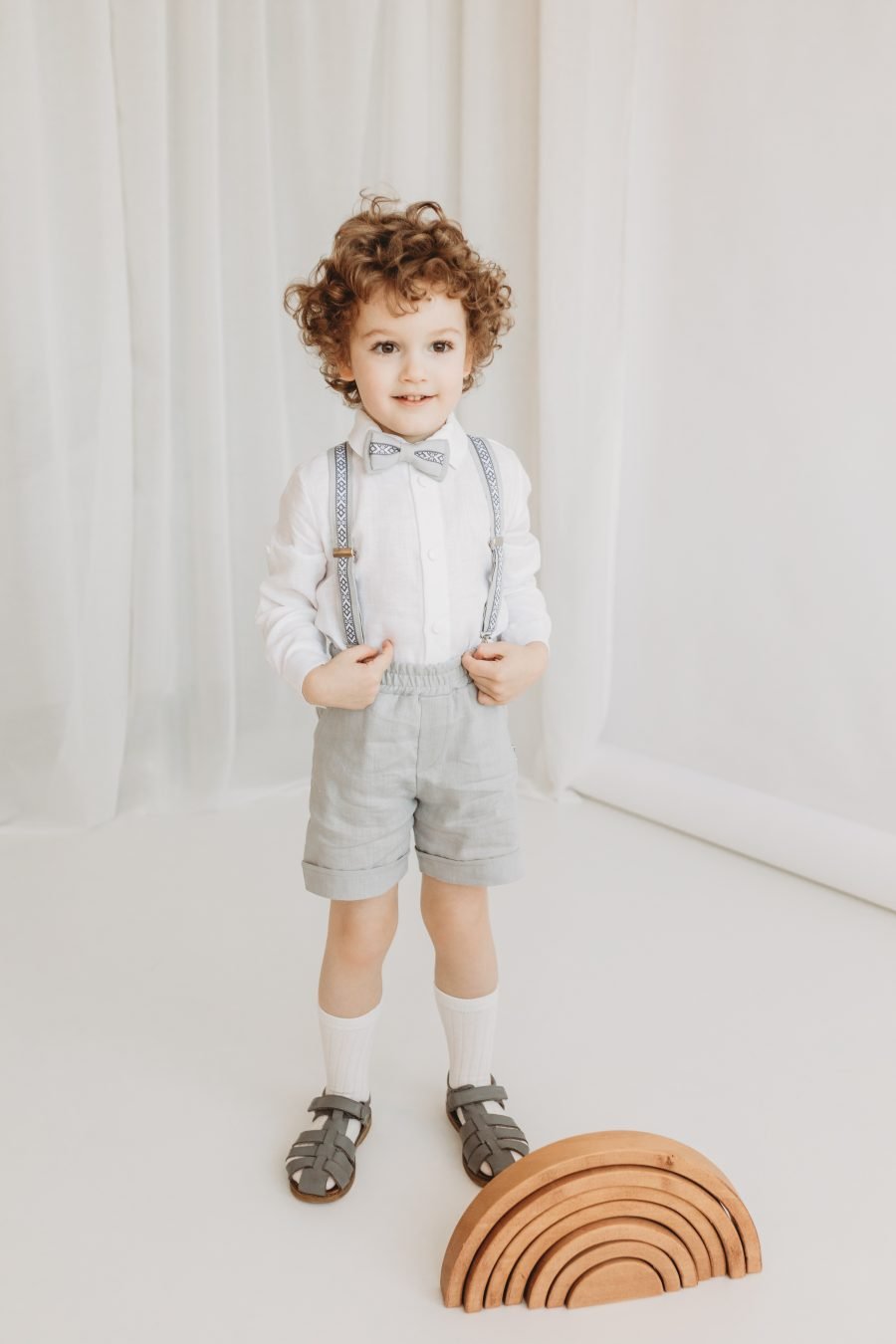 Gray linen suit with shorts, suspenders and bow tie