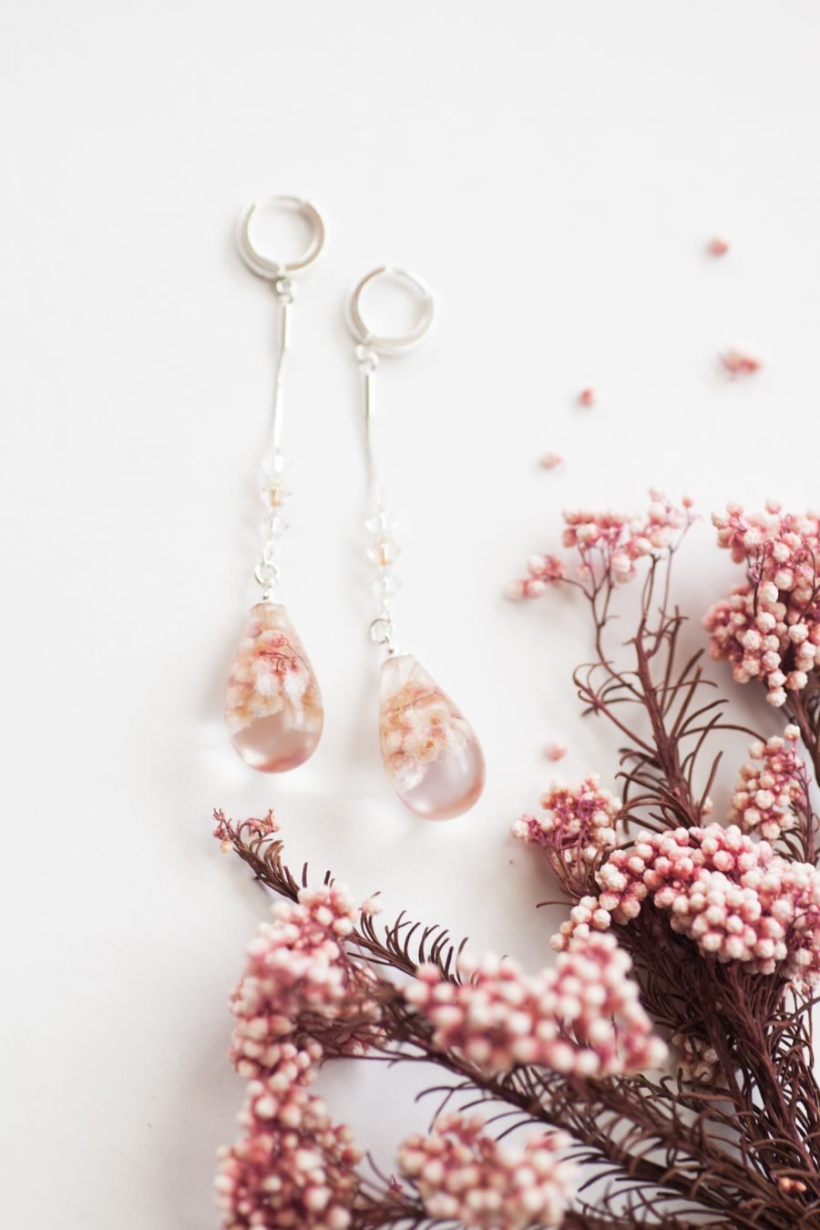 Dangling handmade earrings with pink flowers