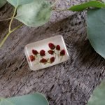 White handmade brooch with strawberries